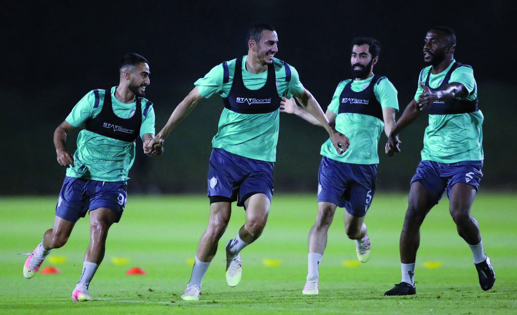 Qatar SC players in action during a practice session on the eve of their match.