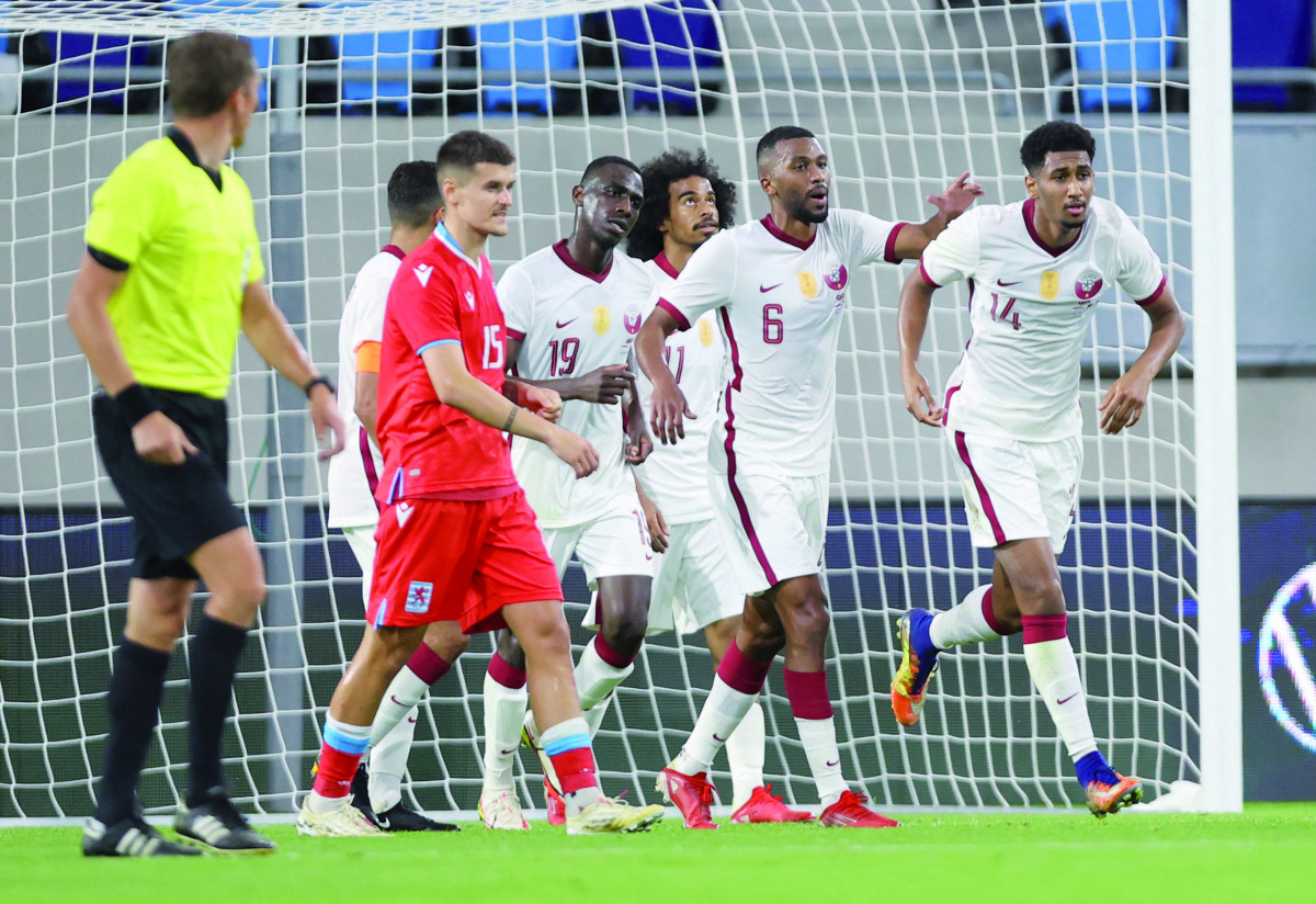 Qatar's Homam Ahmed (right) celebrates with team-mates after scoring a goal against Luxembourg in their European Qualifying match played at Stade de Luxembourg, yesterday.