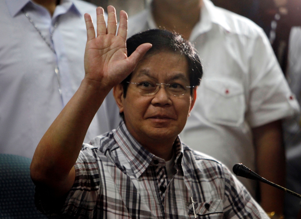 Senator Panfilo Lacson waves to reporters before the start of a news conference at the Senate headquarters in Pasay city, metro Manila March 28, 2011. REUTERS/Romeo Ranoco/File Photo