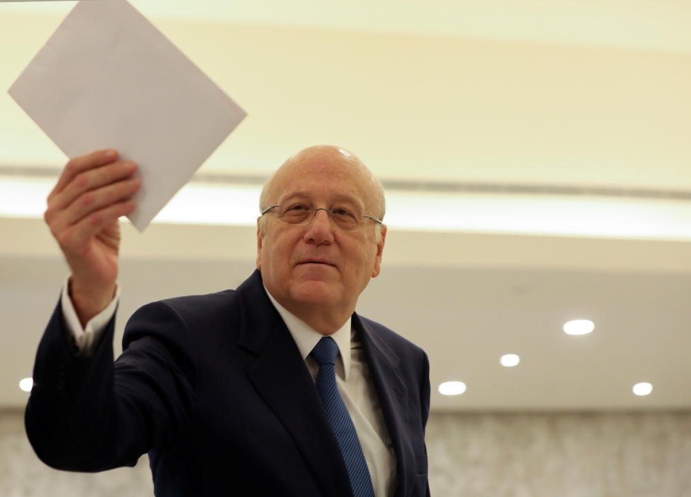 Lebanon's Prime Minister Najib Mikati holds the cabinet line up after meeting with Lebanon's President Michel Aoun at the presidential palace in Baabda, Lebanon September 10, 2021. REUTERS/Mohamed Azakir