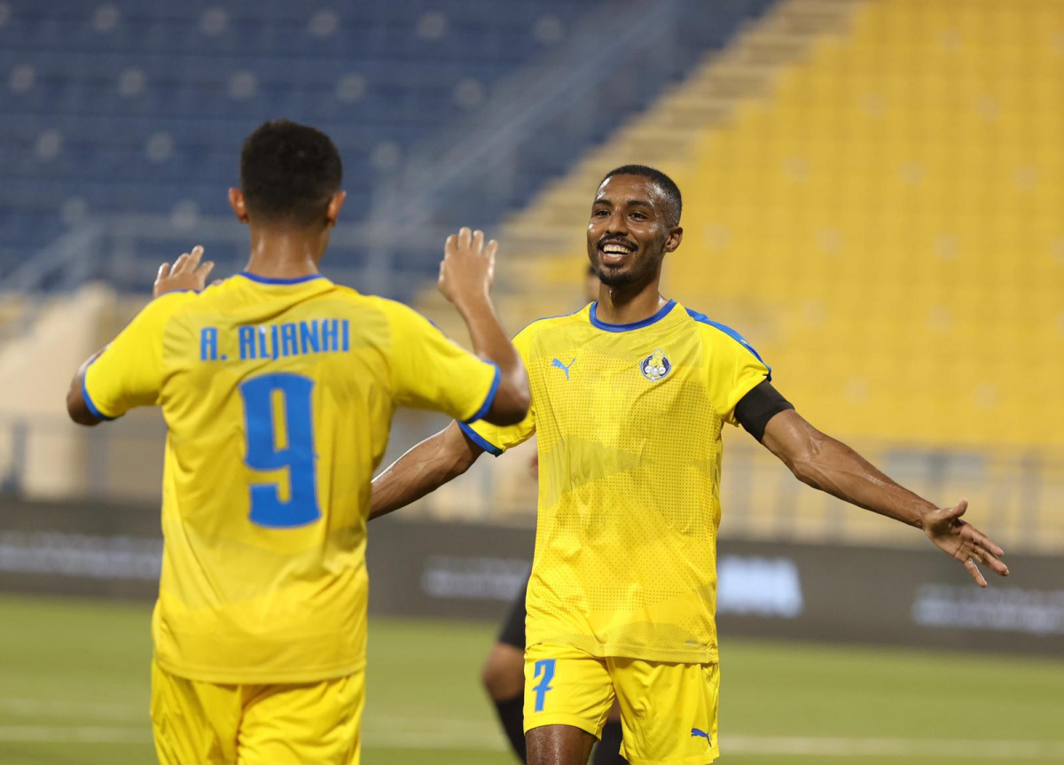 Al Gharafa captain Moyad Hassan celebrates with team-mate Ahmed Al Janehi after scoring their second goal against Al Shamal at Al Gharafa Stadium, yesterday.