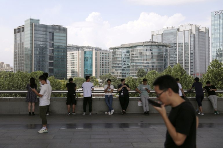 People are seen at Beijing's tech hub Zhongguancun, China August 23, 2021. REUTERS/Tingshu Wang
