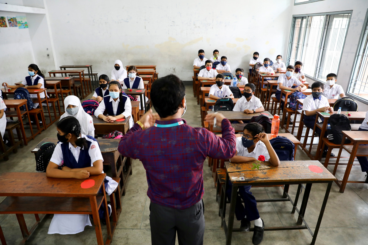 Students attend a class at the Udayan Uchcha Madhyamik Bidyalaya after the government has withdrawn restrictions on educational institutions after a decrease in the number of cases of coronavirus disease (COVID-19) in Dhaka, Bangladesh, September 12, 2021