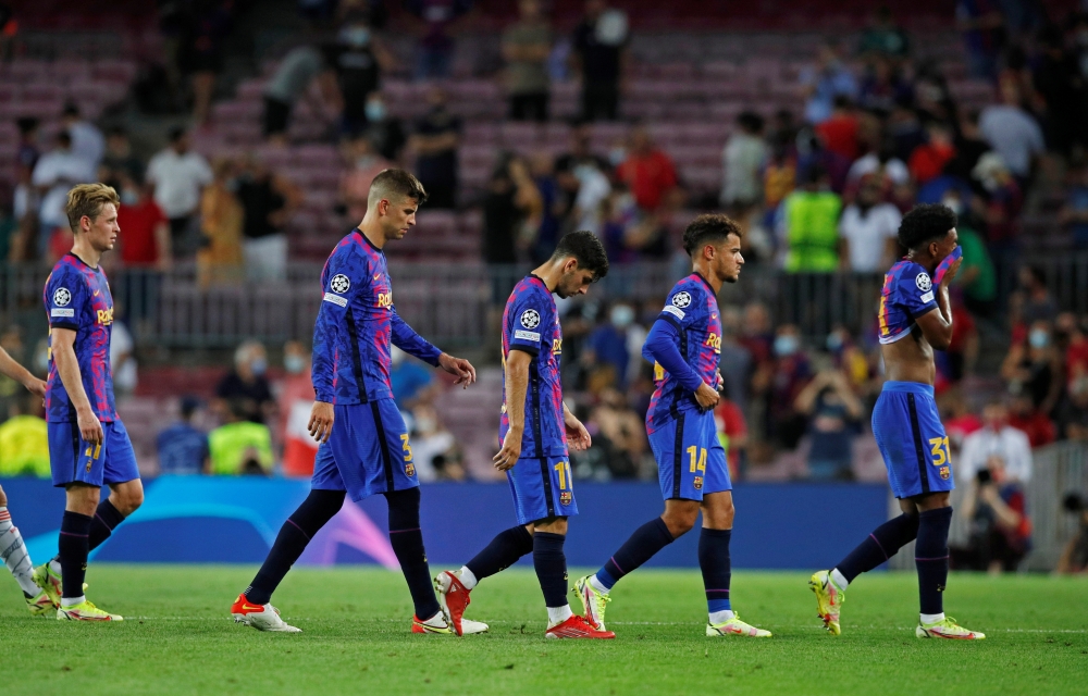  FC Barcelona's Gerard Pique and teammates look dejected after the match REUTERS/Albert Gea 