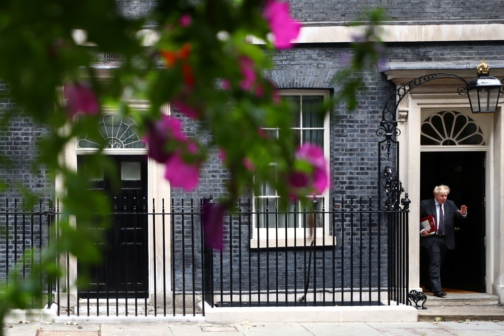 Britain's Prime Minister Boris Johnson gestures as he walks outside Downing Street in London, Britain, September 15, 2021. Reuters/Hannah McKay