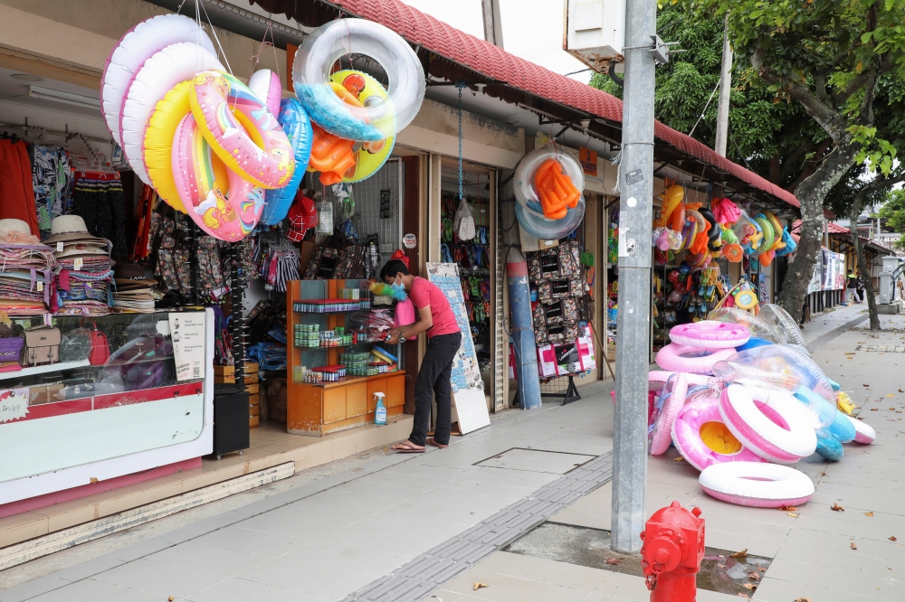 A vendor tidies up his shop, as Langkawi gets ready to open to domestic tourists from September 16, amid the coronavirus disease (COVID-19) pandemic, in Malaysia September 15, 2021. REUTERS/Lim Huey Teng