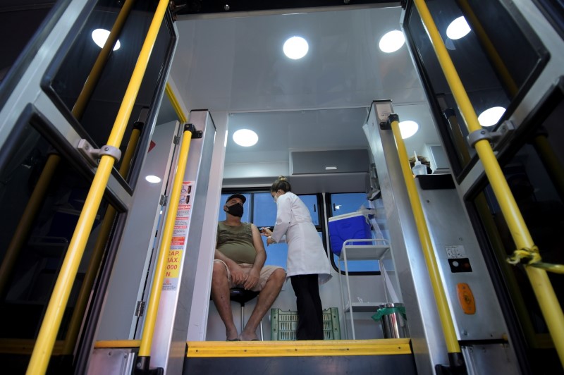 A resident receives a dose of a vaccine against the coronavirus disease (COVID-19) inside the 