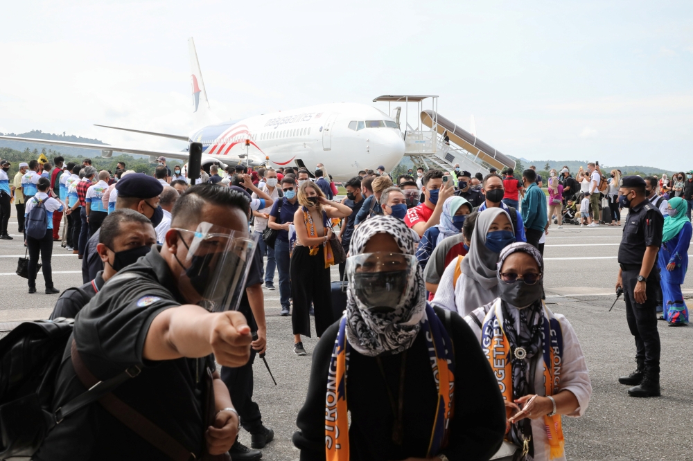 Tourists arrive at the airport as Langkawi reopens to domestic tourists, amid the coronavirus disease (COVID-19) pandemic, in Malaysia September 16, 2021. REUTERS/Lim Huey Teng