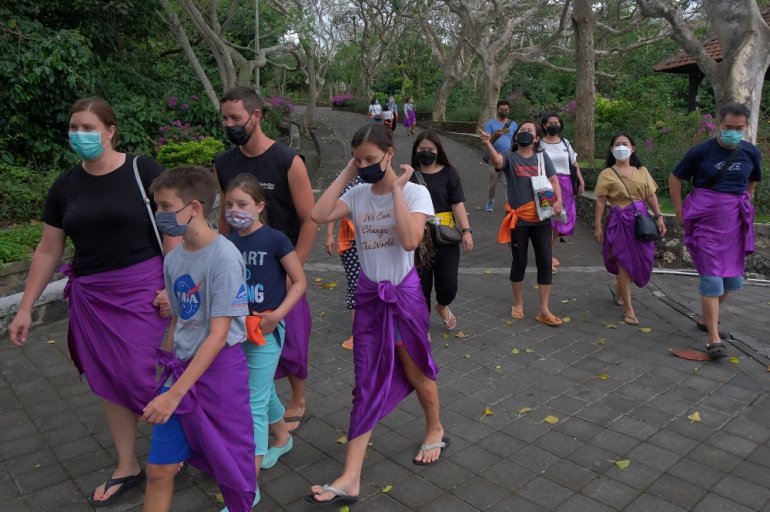 People wear protective face masks on the first day of trial opening for tourist attractions amid the coronavirus disease (COVID-19) outbreak in Badung, Bali, Indonesia September 13, 2021, in this photo taken by Antara Foto/Nyoman Hendra Wibowo/via REUTERS