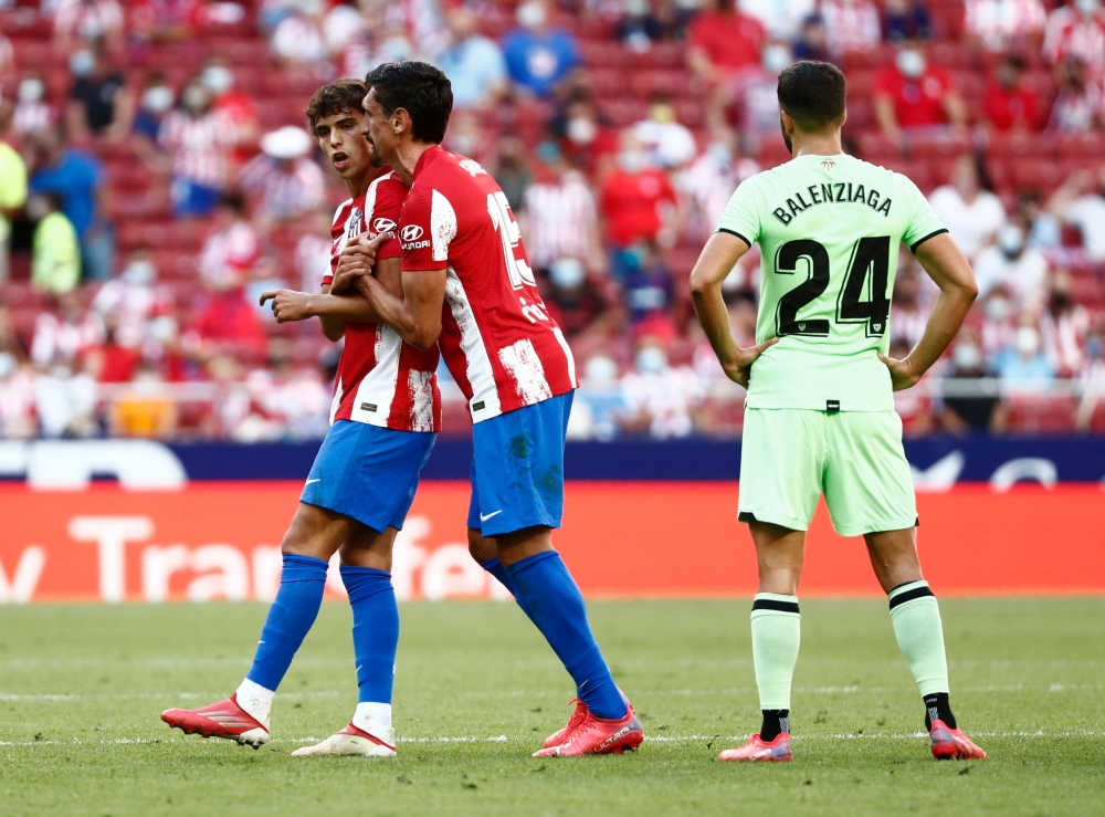 Atletico Madrid's Stefan Savic talks to Joao Felix after he is shown a red card by referee Jesus Gil Manzano REUTERS/Sergio Perez