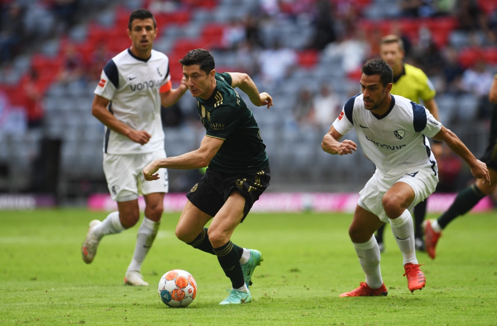 Bayern Munich's Robert Lewandowski in action with VfL Bochum's Vasilis Lampropoulos REUTERS/Andreas Gebert DFL regulations prohibit any use of photographs as image sequences and/or quasi-video.