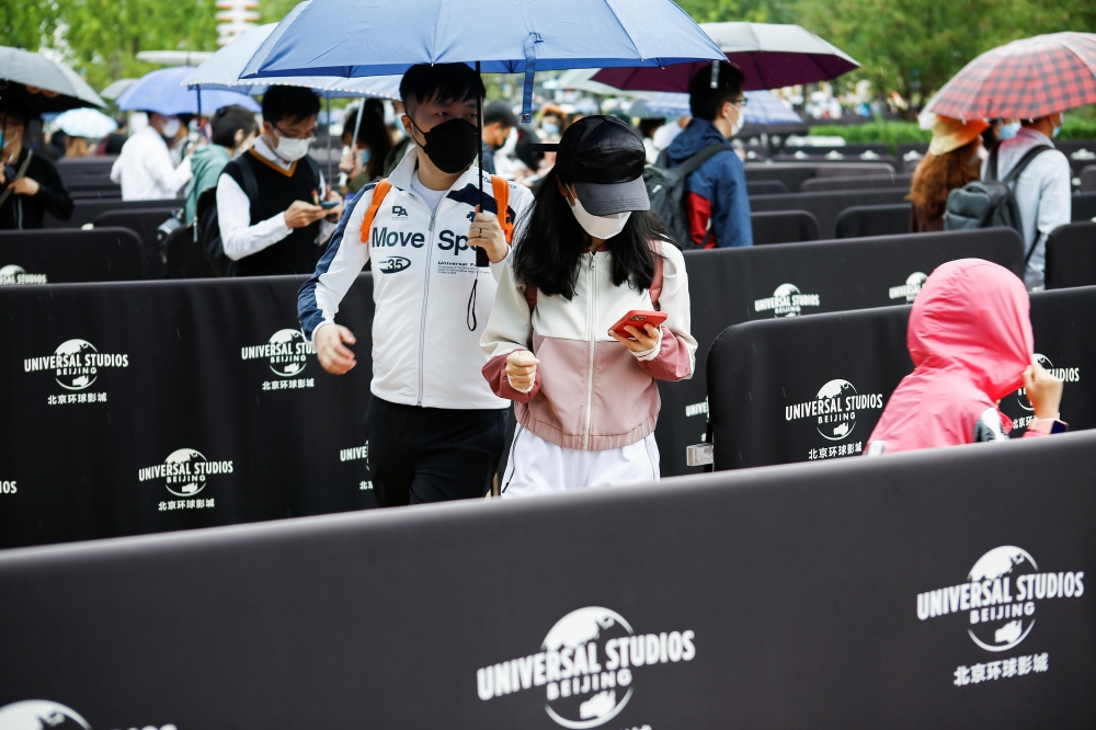 Visitors enter the Universal Beijing Resort as the Universal Studios theme park opens to the general public, in Beijing, China, September 20, 2021. Reuters/Florence Lo
 