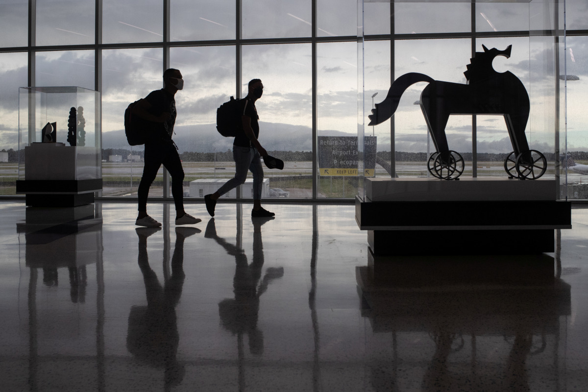 Passengers walk past artwork between terminals at IAH George Bush Intercontinental Airport amid the coronavirus disease (COVID-19) outbreak in Houston, Texas, U.S., July 21, 2020. REUTERS/Adrees Latif

