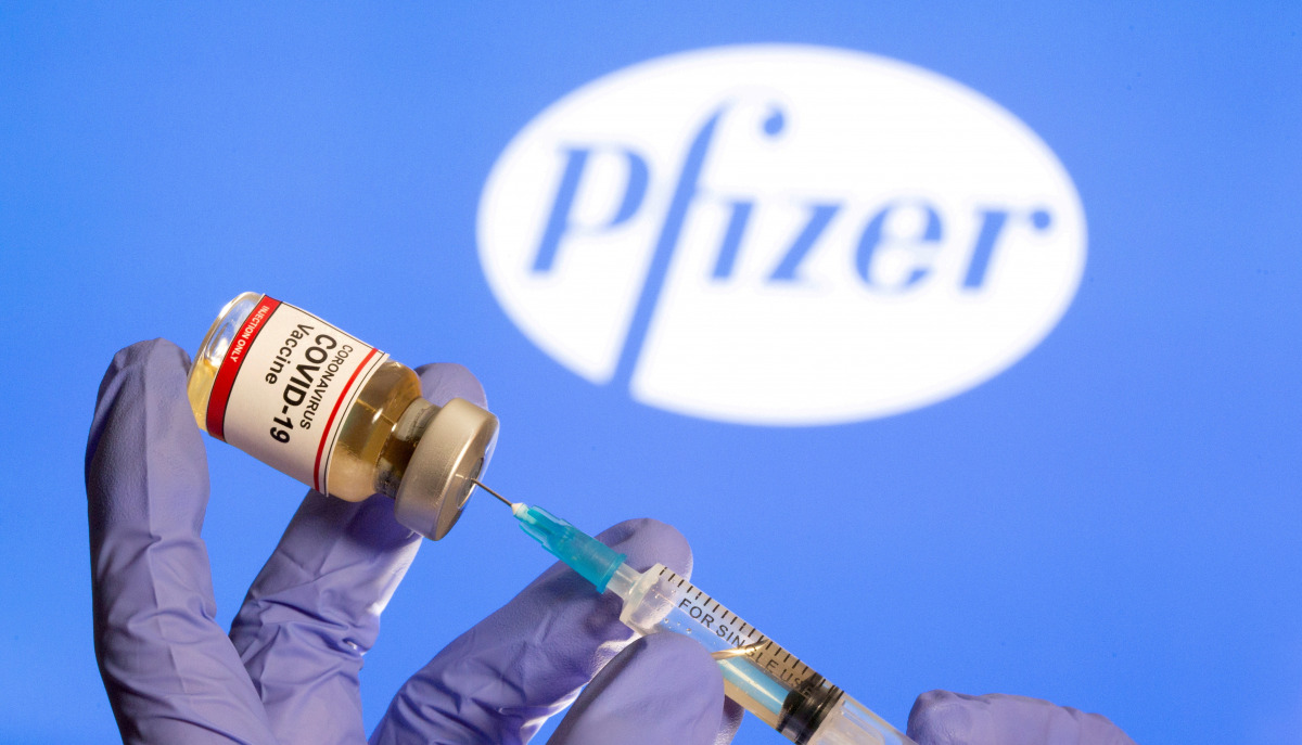 FILE PHOTO: A woman holds a small bottle labeled with a 