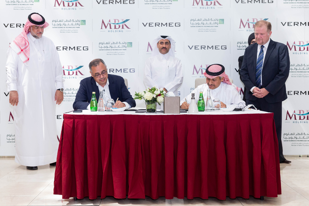 Sheikh Mansour bin Khalifa Al Thani (second right), Chairman of the Board of Directors of MBK Holding Group, and Badr El Din Wali (second left), Founder and Chairman of the Board of Directors of Vermeg International, signing the partnership agreement in D