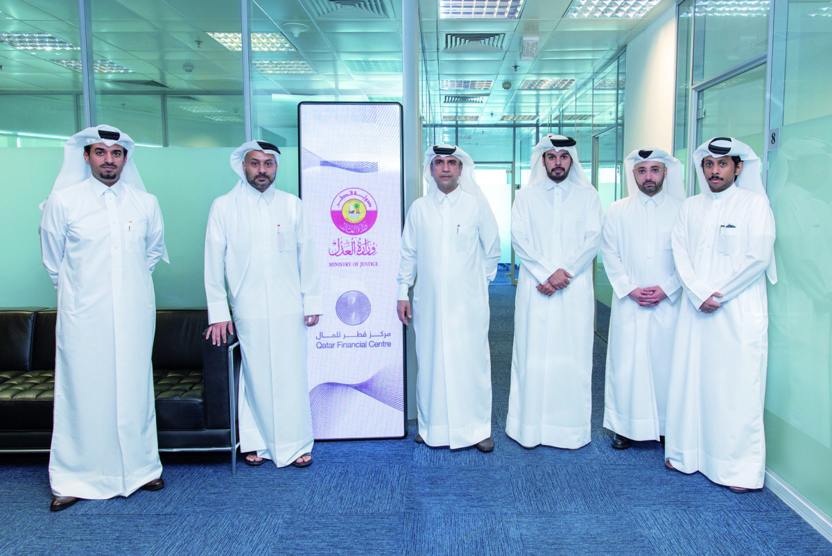 Officials from the Ministry of Justice (MoJ) and Qatar Financial Centre (QFC) during the opening of the new MoJ office at the QFC, in Doha, recently.