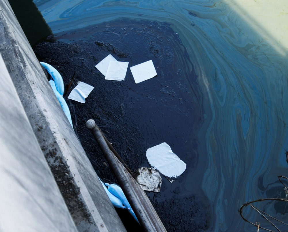 Oil slicks make their way into the Talbert Channel after a major oil spill off the coast of California has come ashore in Huntington Beach, California, U.S. October 3, 2021. REUTERS/Gene Blevins