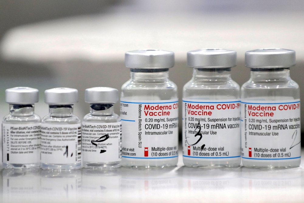 Vials of coronavirus disease (COVID-19) vaccines of Pfizer-BioNTech and Moderna are seen in the town of Ricany near Prague, Czech Republic, February 25, 2021. REUTERS/David W Cerny/File Photo