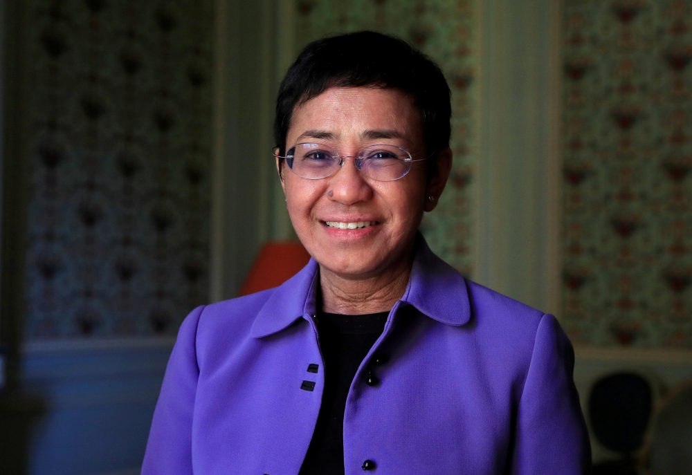 Maria Ressa, journalist and CEO of the Rappler news website, poses before a news conference to launch a commission to draft an 