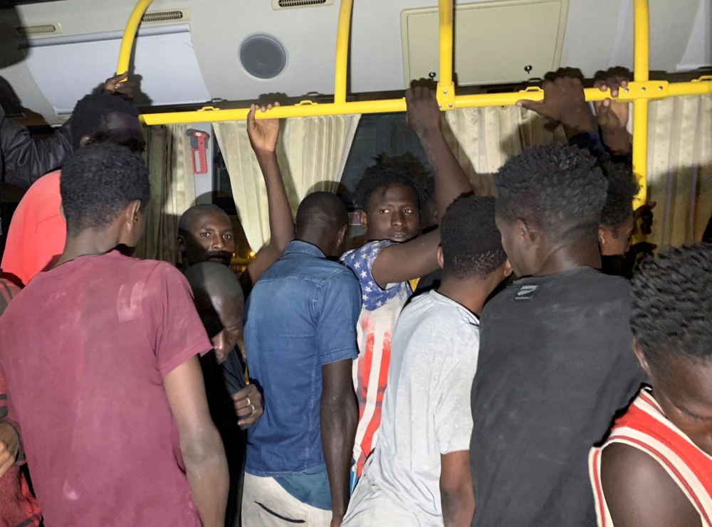 Migrants stand after they were detained by Libyan security forces in Tripoli, Libya October 8, 2021. REUTERS/Ayman Al-Sahili