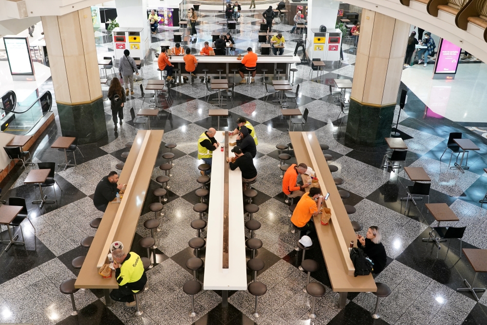 Diners sit to eat at a city centre food court on the first day of eased restrictions for vaccinated patrons in Sydney, Australia, October 11, 2021. Reuters/Loren Elliott