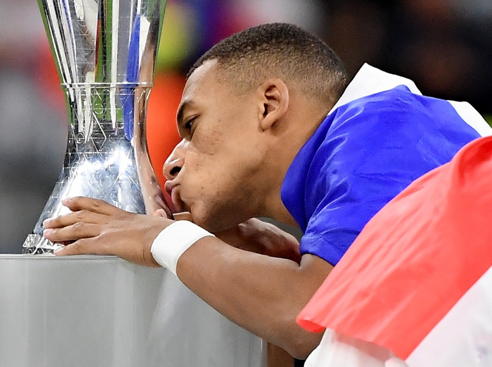 France's Kylian Mbappe kisses the Nations League trophy after the match REUTERS/Alberto Lingria

