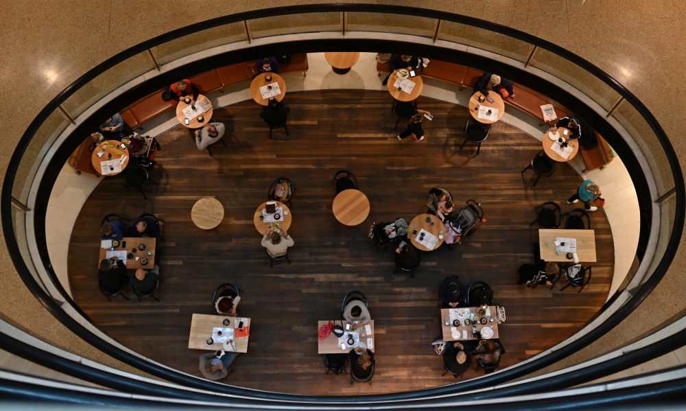 Shoppers sit at tables inside Westfield Bondi Junction as businesses re-open to vaccinated patrons in the wake of coronavirus disease (COVID-19) regulations easing, following months of lockdown orders to curb an outbreak of cases, in Sydney, Australia, Oc