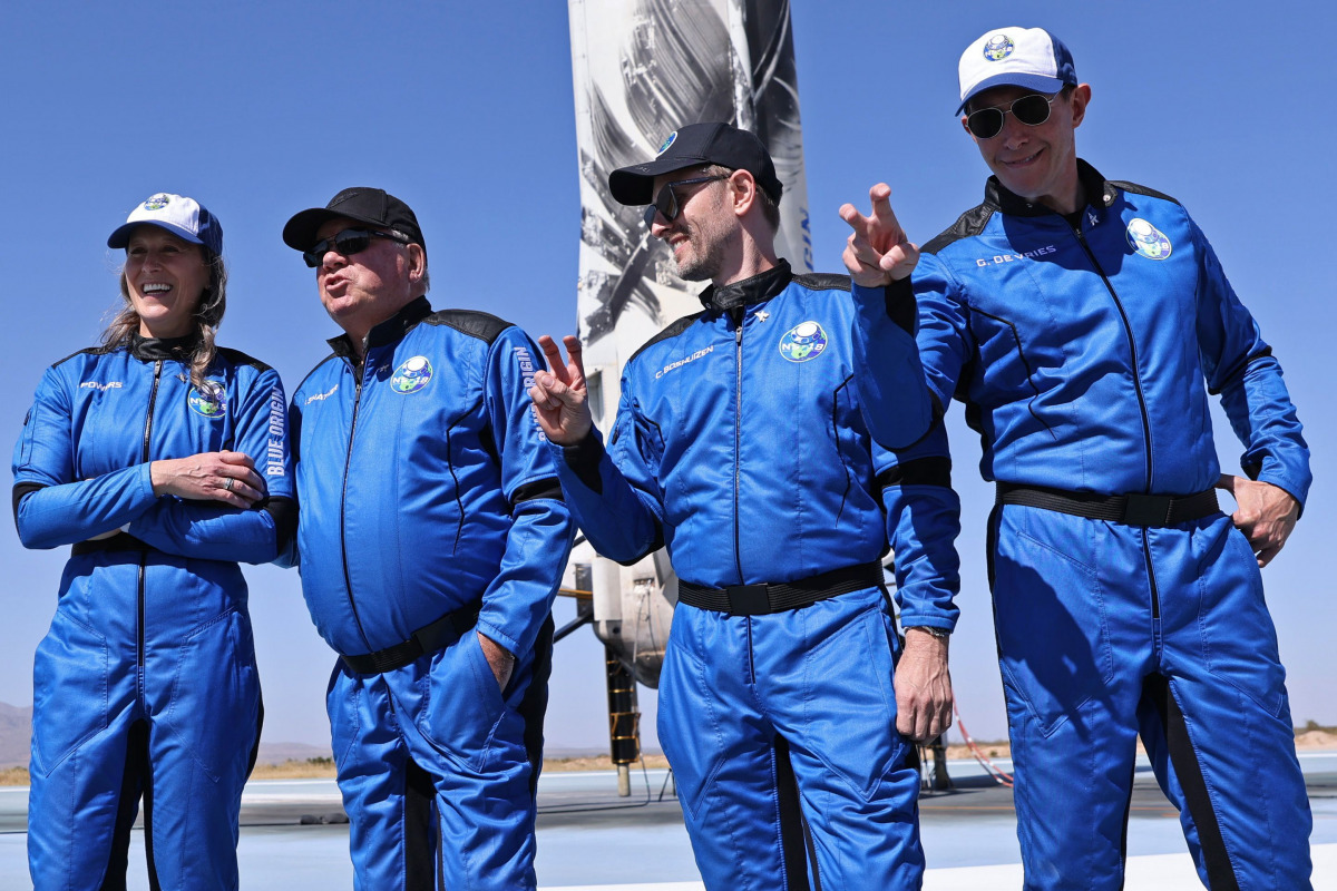 Chris Boshuizen, the co-founder of satellite company Planet Labs and a former space mission architect for NASA and Glen de Vries, the co-founder of Medidata Solutions, a life science company gesture as Star Trek actor William Shatner speaks to the news me
