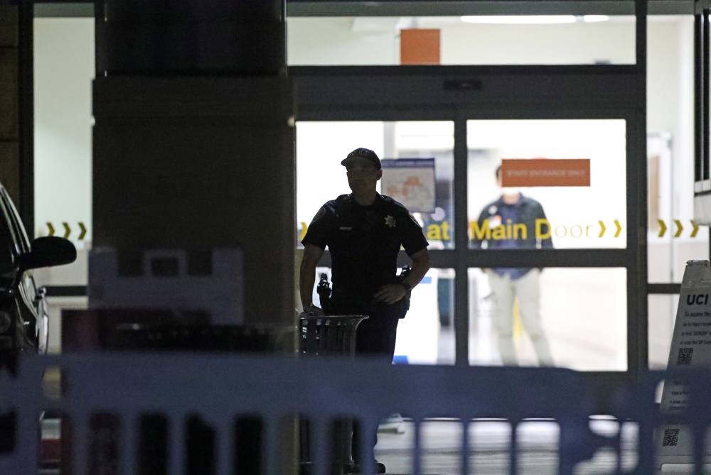 A police personnel stands at an entrance of the University of California Irvine Douglas Hospital, after former U.S. President Bill Clinton was admitted to the UCI Medical Center, in Orange, California, U.S. October 14, 2021. REUTERS/David Swanson
