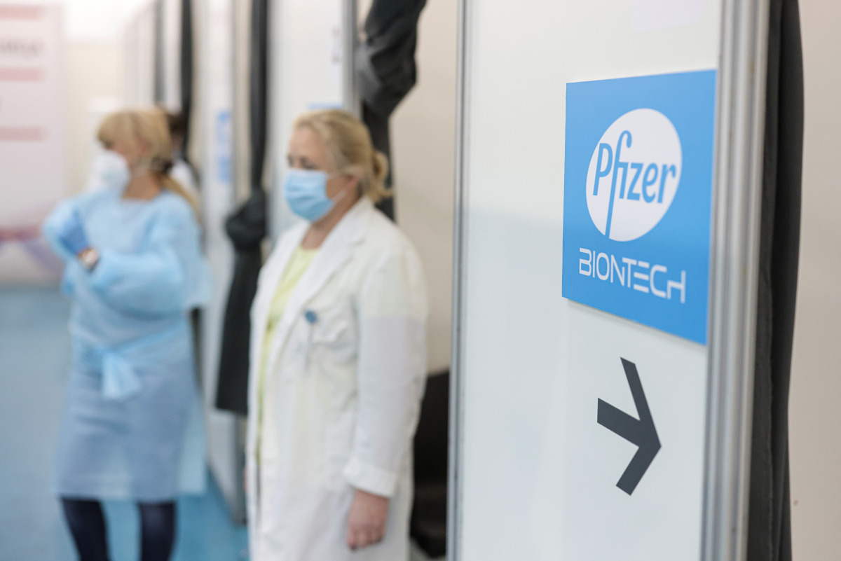 Healthcare workers wait in front of booths where people receive a dose of Pfizer's coronavirus disease (COVID-19) vaccine at Belgrade Fair vaccination center in Belgrade, Serbia, October 15, 2021. REUTERS/Marko Djurica
