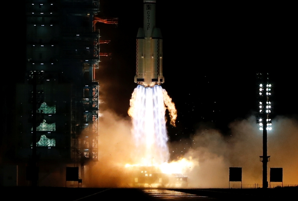 The Long March-2F Y13 rocket, carrying the Shenzhou-13 spacecraft and three astronauts in China's second crewed mission to build its own space station, launches at Jiuquan Satellite Launch Center near Jiuquan, Gansu province, China October 16, 2021. REUTE