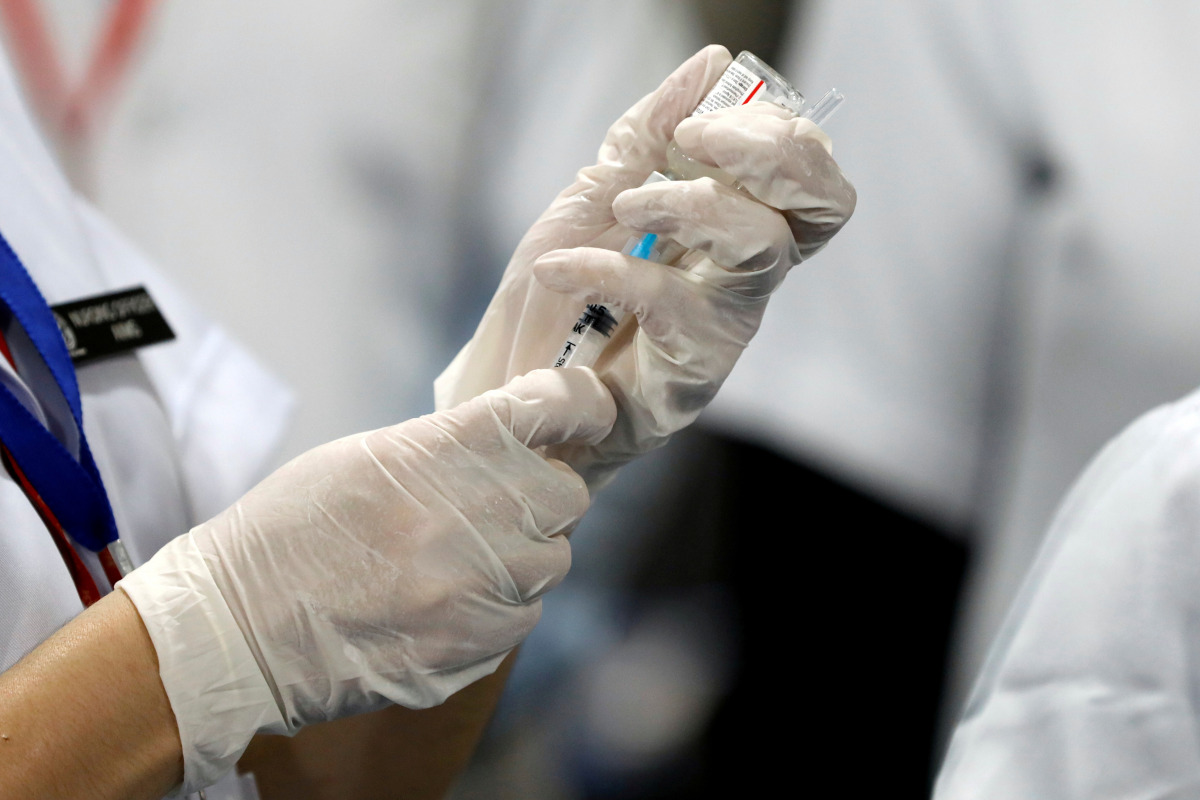 FILE PHOTO: A healthcare worker fills a syringe with a dose of Bharat Biotech's COVID-19 vaccine called Covaxin, during the coronavirus disease (COVID-19) vaccination campaign at All India Institute of Medical Sciences (AIIMS) hospital in New Delhi, India