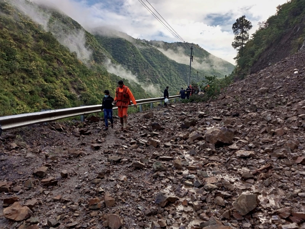 Members of National Disaster Response Force (NDRF) evacuate stranded people following heavy rains at Chhara village in Nainital district, in the northern state of Uttarakhand, India, October 20, 2021. National Disaster Response Force/Handout via REUTERS