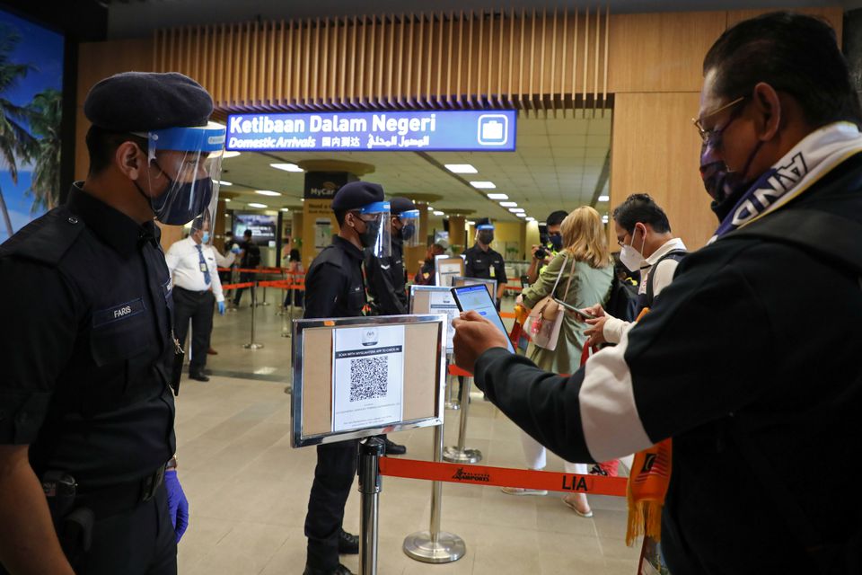 File photo of a tourist scanning a QR code in Malaysia used for representation