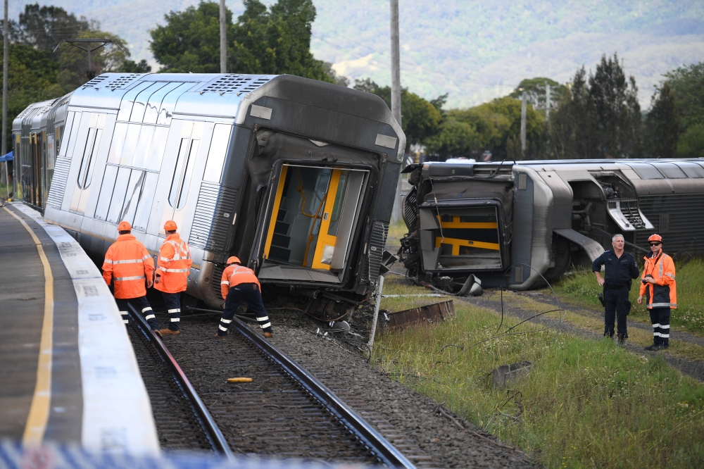 A derailed passenger train is seen after it hit a car on a level crossing in Kembla Grange, Australia, October 20, 2021. AAP Image/Dean Lewins via REUTERS