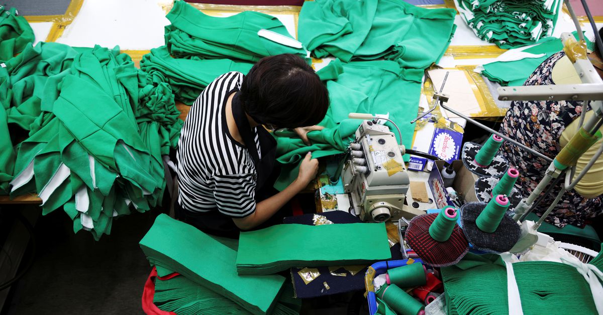 A woman works on tracksuits inspired by Netflix series 