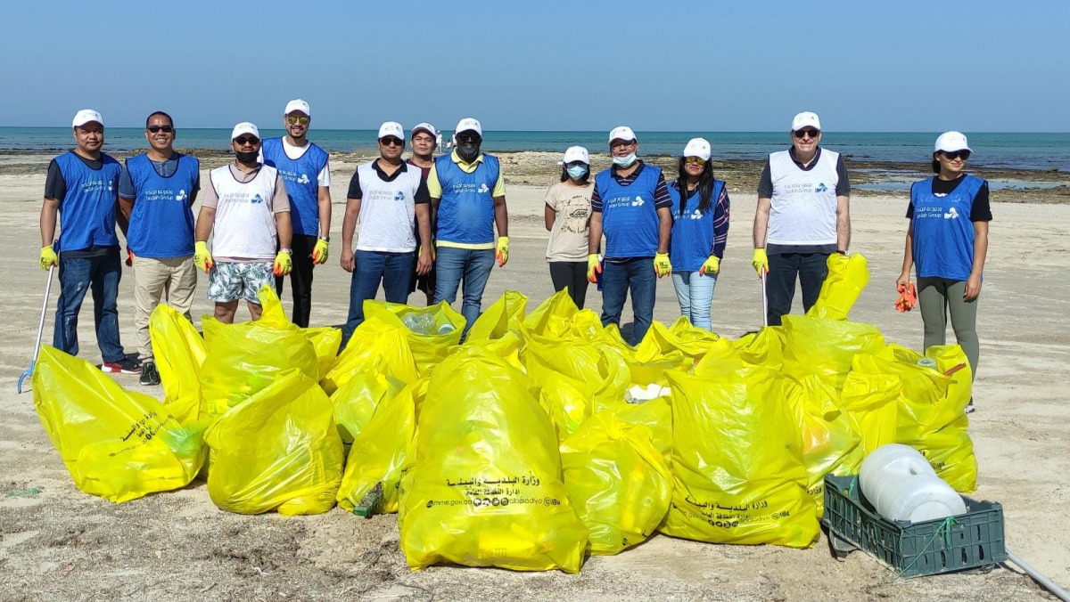 Employees from Jaidah Motors during a drive to clean Abu Zalub beach organised by General Cleanliness Department.