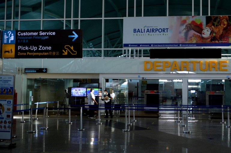 People are seen at Ngurah Rai International Airport ahead of the reopening of Indonesia's resort island of Bali on Thursday, in Badung, Bali, Indonesia October 13, 2021. Antara Foto/Fikri Yusuf/via Reuters