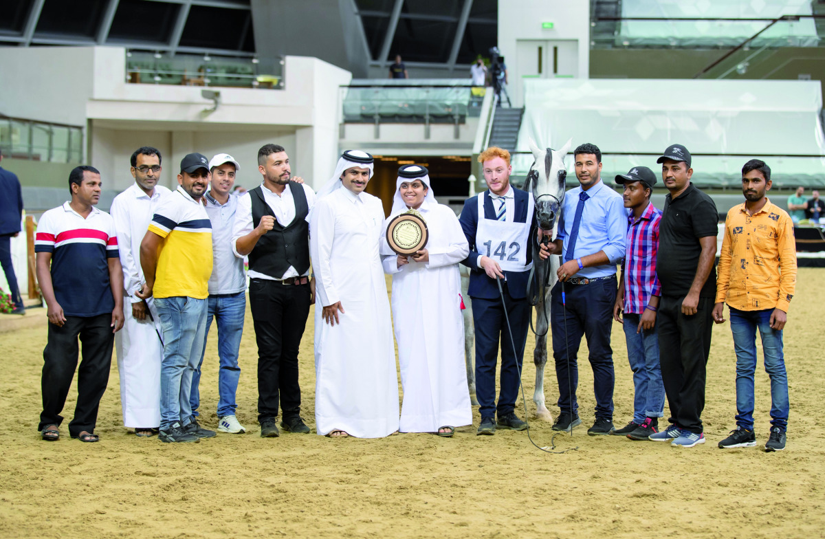 The connection of Ghazi Al Nasser, winner of Senior Stallions Championship at the 1st Qatar Arabian Horse Show Local Bred Championships, pose for a photograph with the gold trophy at Al Shaqab Arena yesterday.