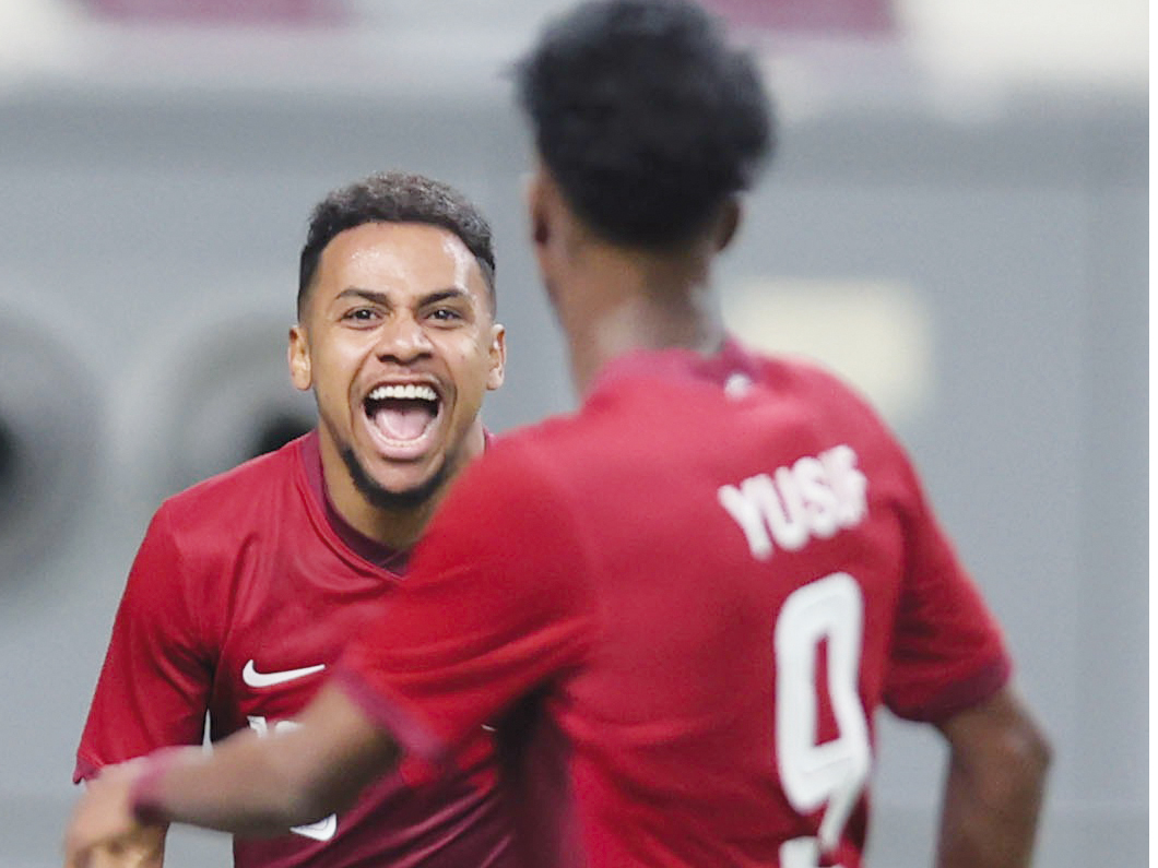 Qatar u23 players celebrate after scoring a goal.