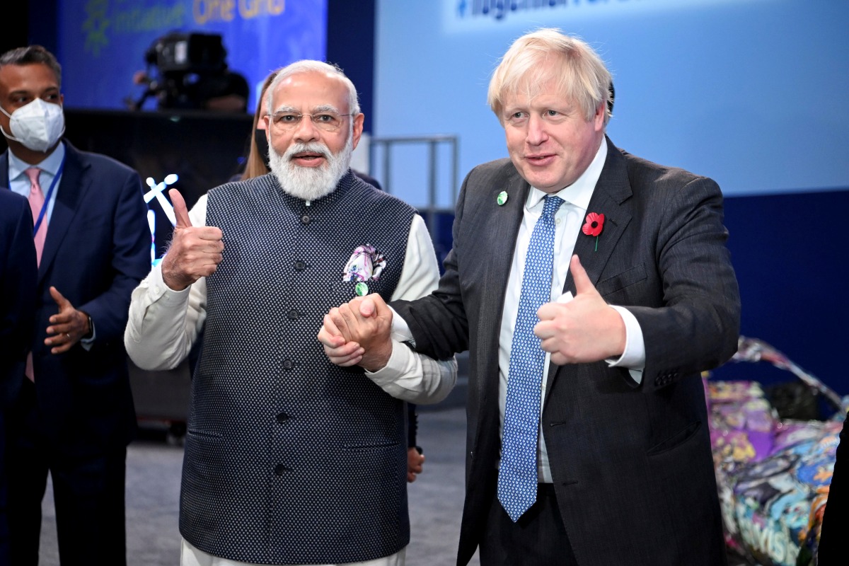 Britain's Prime Minister Boris Johnson and India's Prime Minister Narendra Modi attend the 