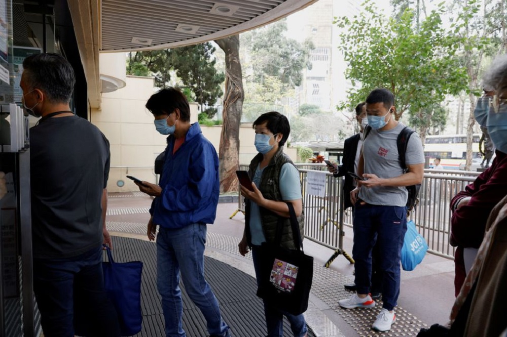 People queue up at a community vaccination centre to receive a dose of the Sinovac Biotech coronavirus disease (COVID-19) vaccine in Hong Kong, China, February 26, 2021. REUTERS/Tyrone Siu
