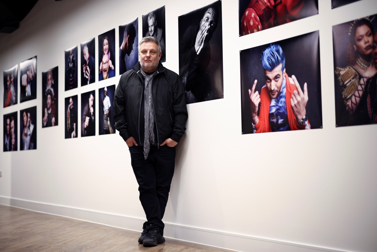 Renowned British photographer Rankin poses for a portrait alongside photographs he has taken for his 'Performance by Rankin' series, in London, Britain, November 3, 2021. REUTERS/Henry Nicholls
