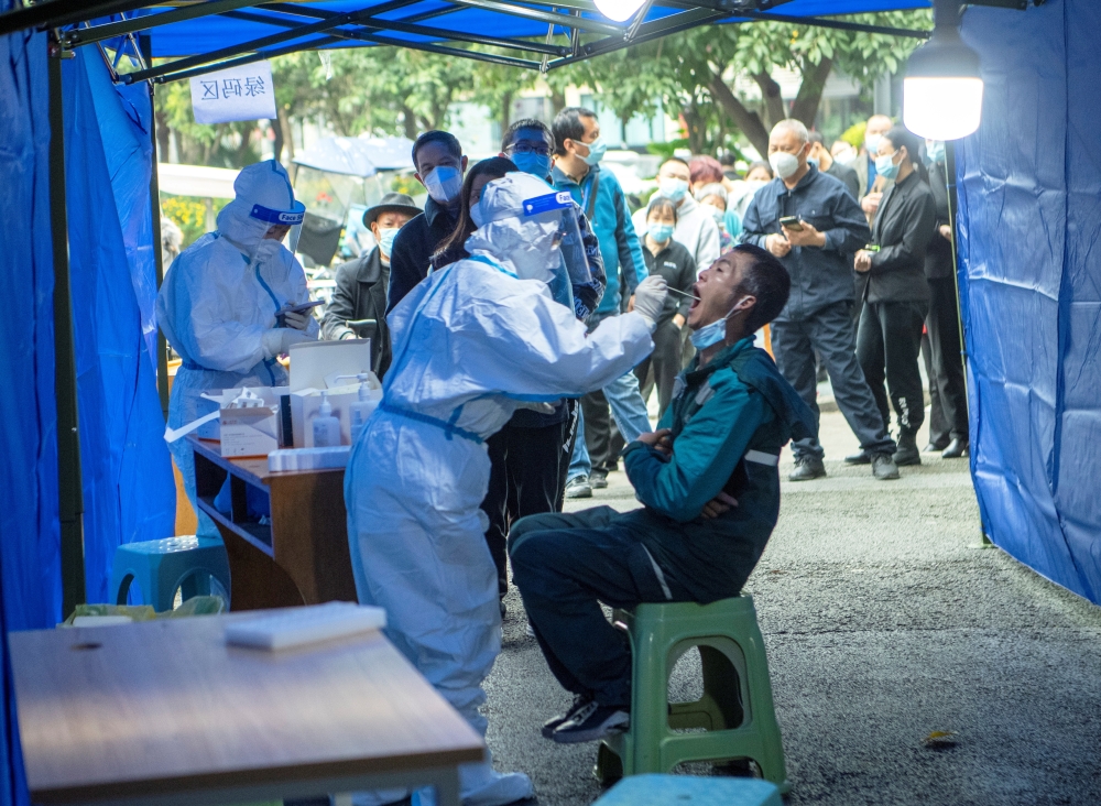 People line up at a makeshift nucleic acid testing site near a residential compound under lockdown following local cases of the coronavirus disease (COVID-19) in Chengdu, Sichuan province, China November 3, 2021. Picture taken November 3, 2021. cnsphoto via REUTERS