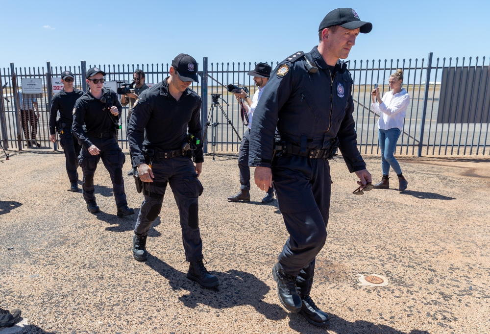 Prison guards arrive on a charter flight to transport the man accused of the abduction of Cleo Smith to Perth from Carnarvon airport, in Carnarvon, Australia, November 5, 2021. AAP Image/Richard Wainwright via REUTERS