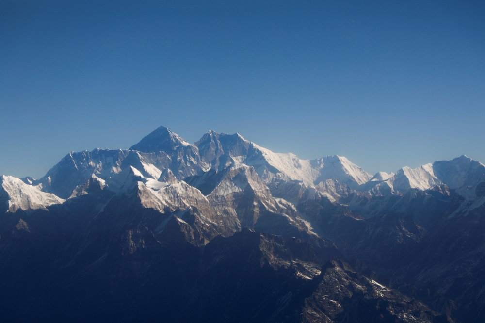 Mount Everest, the world highest peak, and other peaks of the Himalayan range are seen through an aircraft window during a mountain flight from Kathmandu, Nepal January 15, 2020. REUTERS/Monika Deupala/File Photo