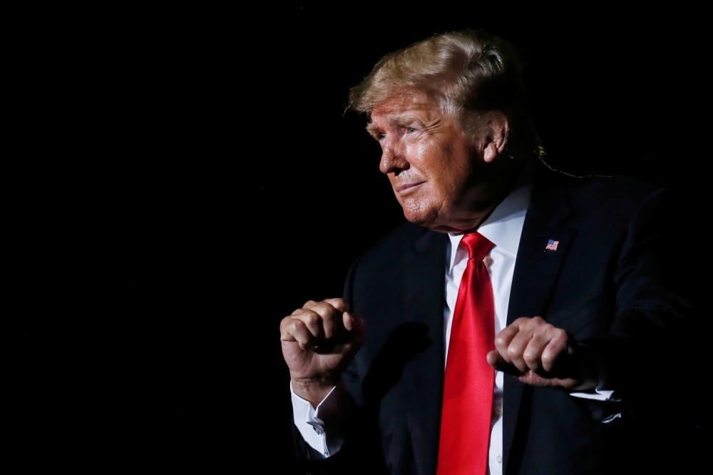 Former U.S. President Donald Trump reacts after his speech during a rally at the Iowa States Fairgrounds in Des Moines, Iowa, U.S., October 9, 2021. Reuters/Rachel Mummey/File Photo