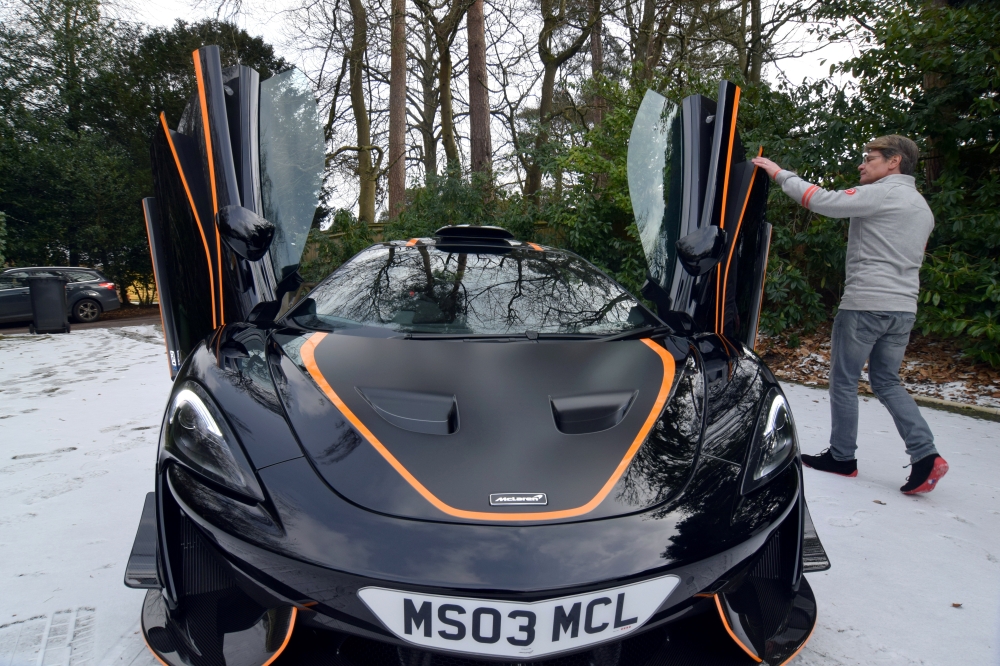 FILE PHOTO: Steve Glynn, who has owned a number of McLarens and says he is willing to try out electric models when they become available, displays his most recently acquired McLaren at his home in Headley Down, Britain February 11, 2021 REUTERS/Nick Carey
