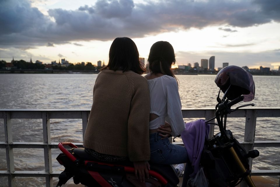 People ride a ferry at sunset on the Mekong River, amid a coronavirus disease (COVID-19) outbreak, in Phnom Penh, Cambodia, August 12, 2021. REUTERS/Cindy Liu/File Photo