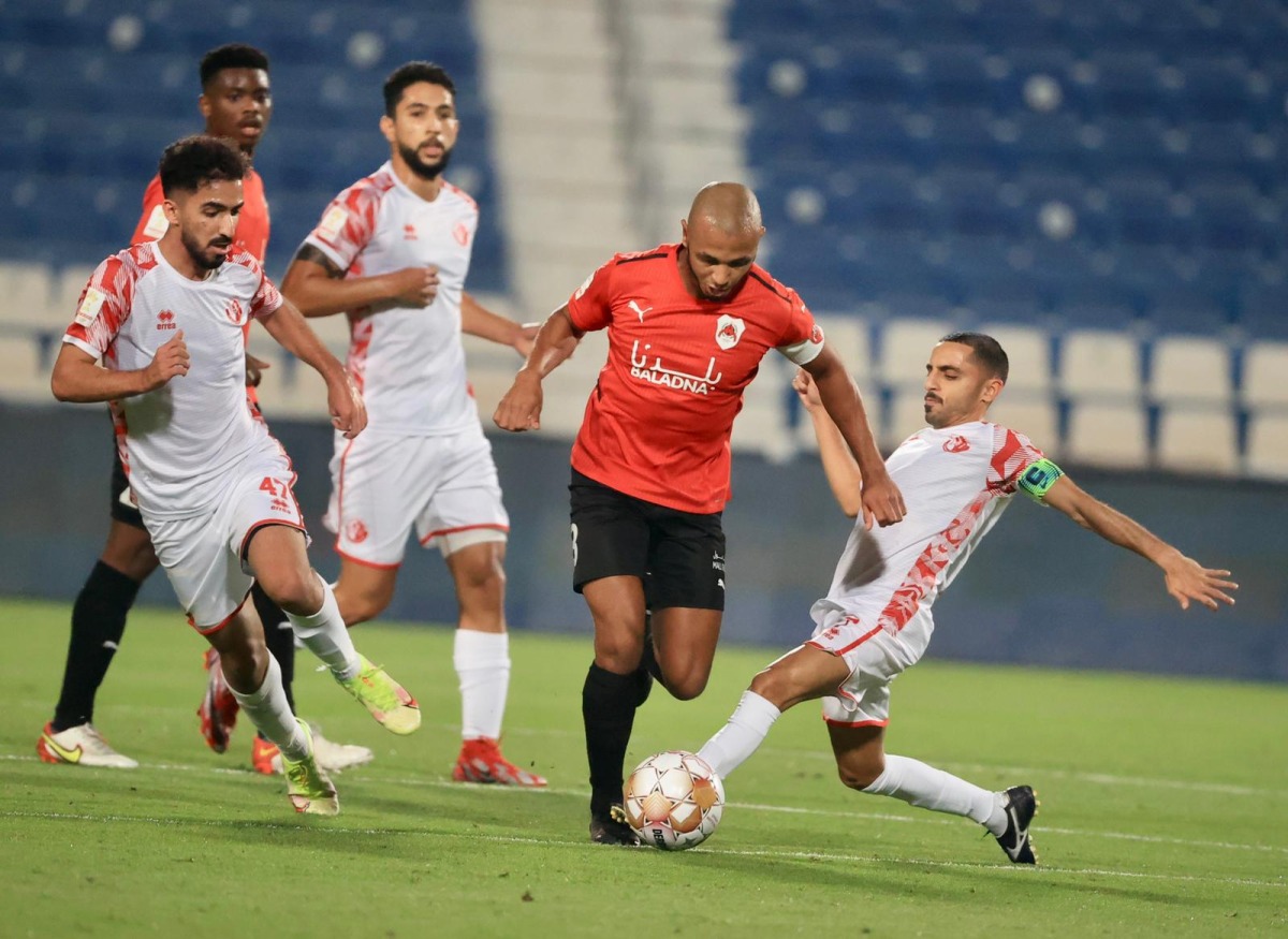 Al Rayyan's Yacine Brahimi vies for the ball possession with Al Shamal players during yesterday's match.